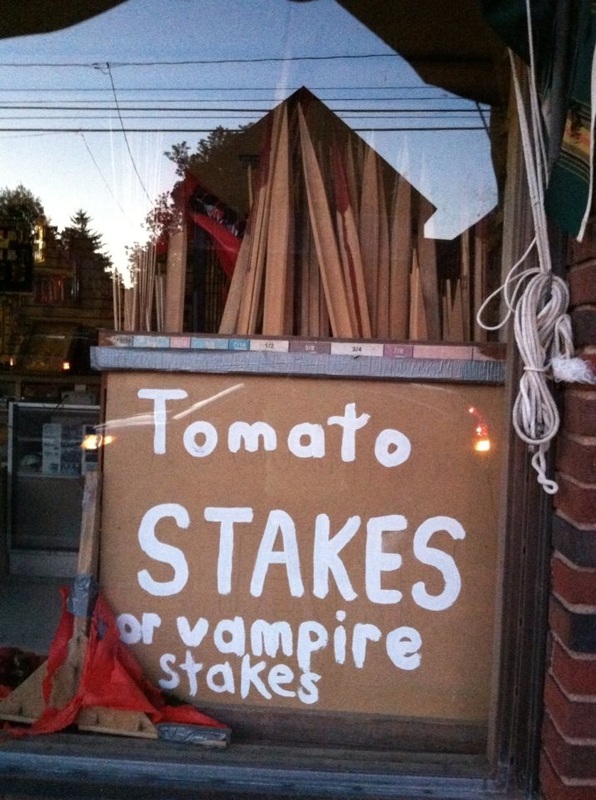 Sign in hardware shop window reading: Tomato Stakes, or Vampire Stakes