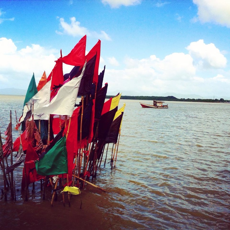 Flags in ocean at Carapachaima Temple, Trinidad
