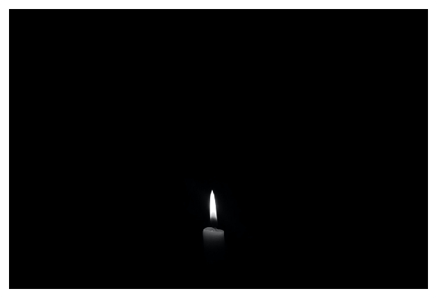 Single black-and-white candle flame in field of pure black
